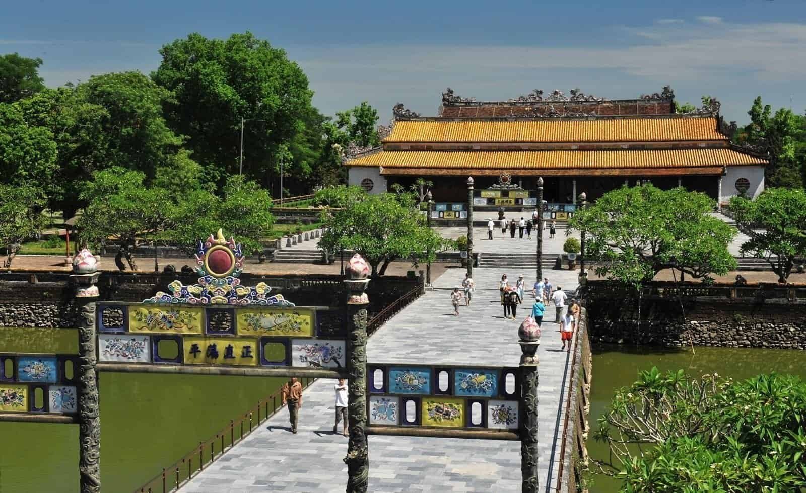 Ancient riverside temple surrounded by limestone mountains in Ninh Binh