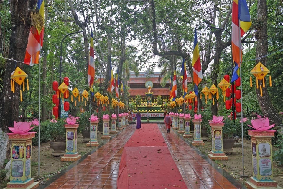 Vietnamese temple walkway decorated with lotus lanterns and Buddhist flags