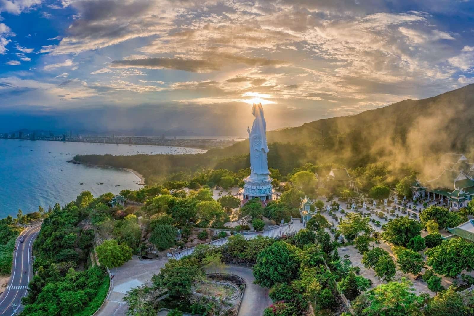Lady Buddha statue overlooking Da Nang coastline at sunset